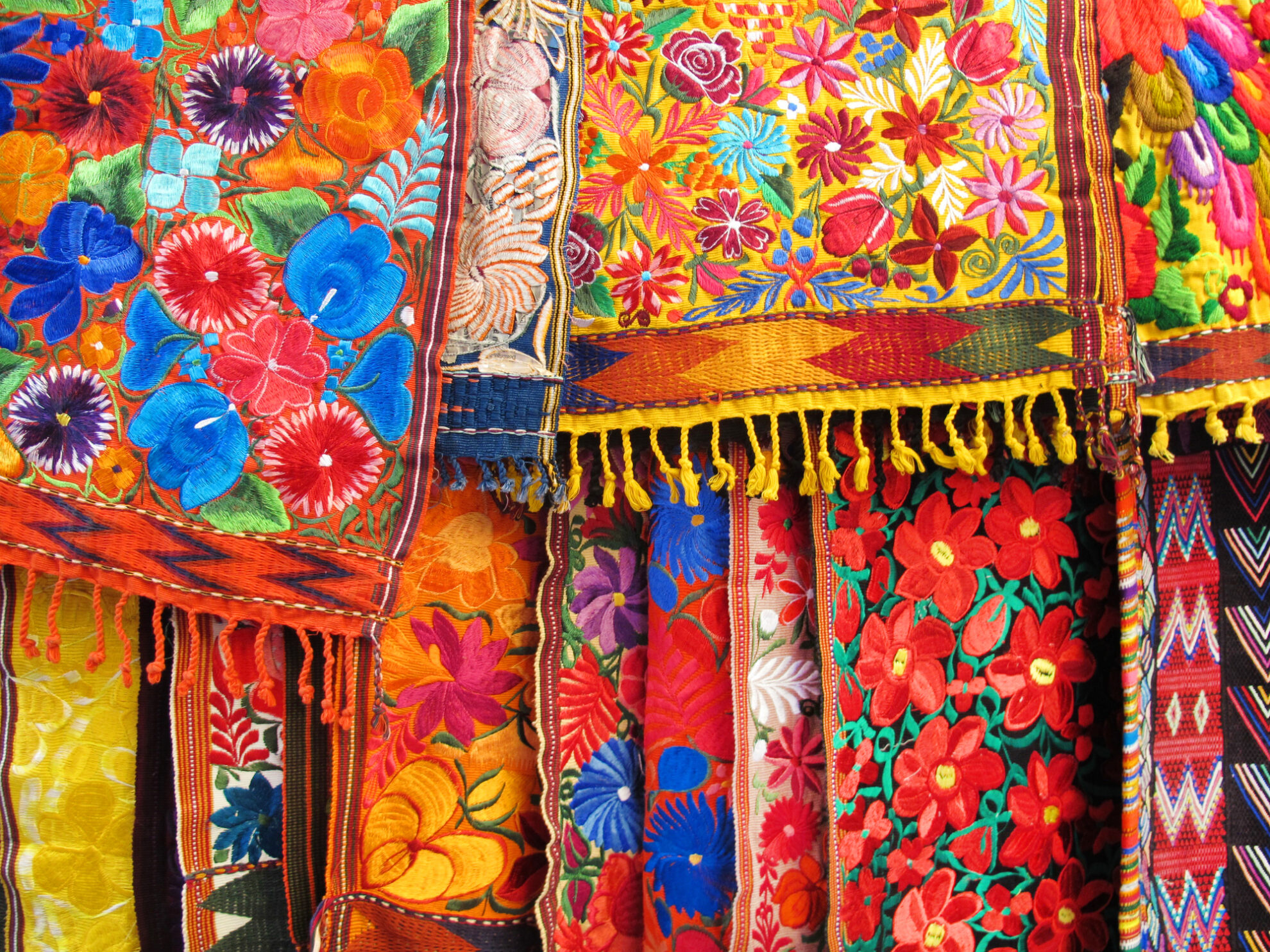 Colorful hand embroidered fabrics and tablecloths in an outdoor market in Mexico City, Mexico